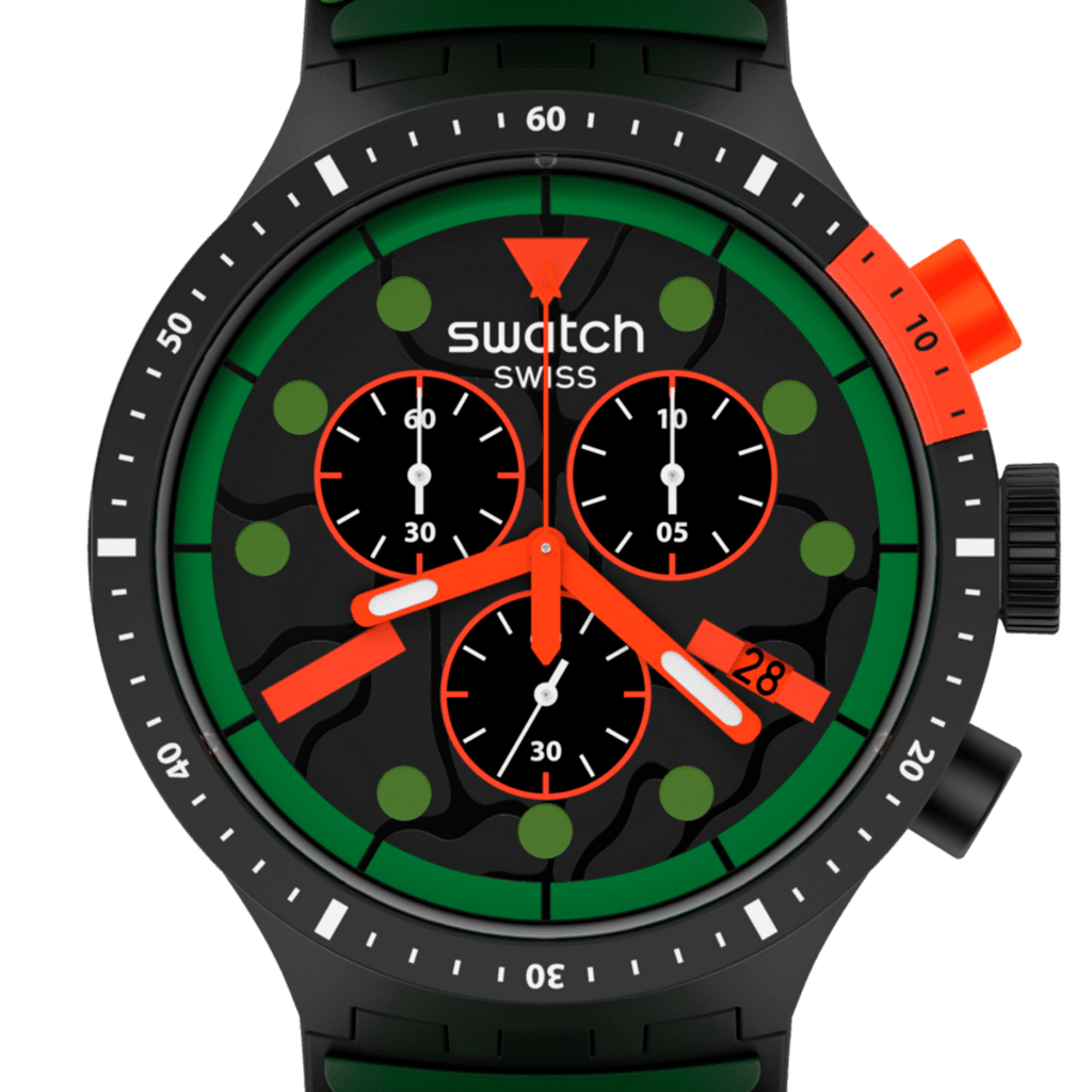 A close-up of a Swatch Swiss analog watch with a black case and dial, featuring a bold green bezel ring, bright orange accents on the crown, pushers, and hands, and green hour markers.