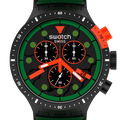 A close-up of a Swatch Swiss analog watch with a black case and dial, featuring a bold green bezel ring, bright orange accents on the crown, pushers, and hands, and green hour markers.