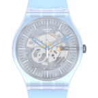 Swatch Swiss automatic watch with a translucent light blue resin case and strap, featuring a skeleton dial with visible gears and blue hands, set against a solid green background.