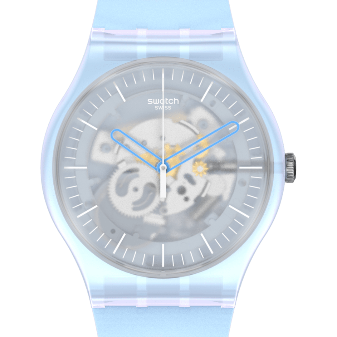 Swatch Swiss automatic watch with a translucent light blue resin case and strap, featuring a skeleton dial with visible gears and blue hands, set against a solid green background.